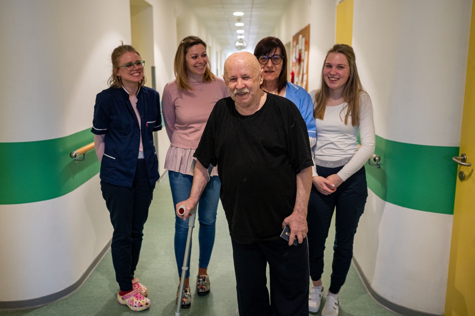 Bego, middle, is surrounded by caregivers at the Home for Older People in Glina, Croatia, reconstructed through the Regional Housing Programme.