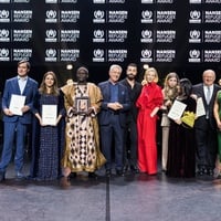 A group of people stand in a line on a stage