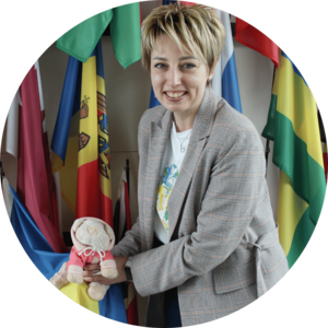 A Ukrainian woman poses with a small toy pig