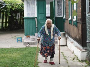 Halyna, 97, in the yard of her house in Kyiv Oblast. It was repaired by UNHCR after being damaged by artillery fire.