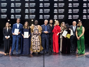 A group of people stand in a line on a stage