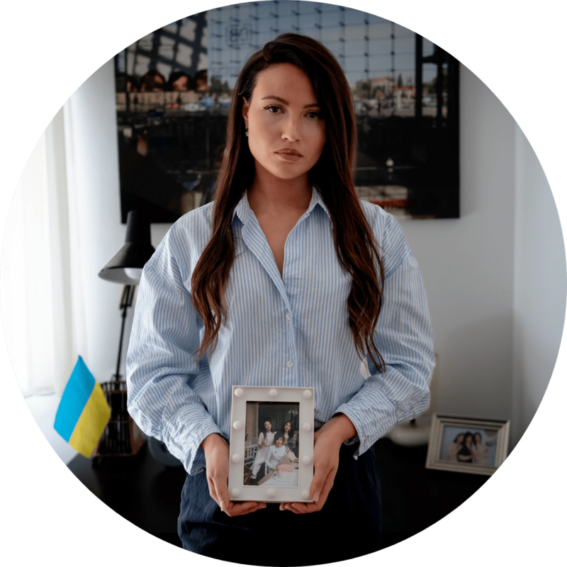 A Ukrainian woman holds a framed photo of her family