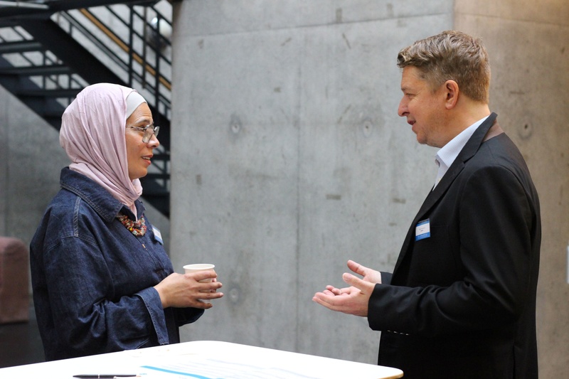Two participants talk during a break out session at the NGO Consultations in Geneva 