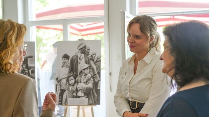 People talking at a photo exhibition