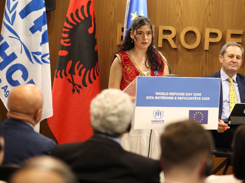 Katerin, who arrived in Albania from Venezuela as a child, speaks at a World Refugee Day event in Tirana, reflecting on how education helped her rebuild her future.