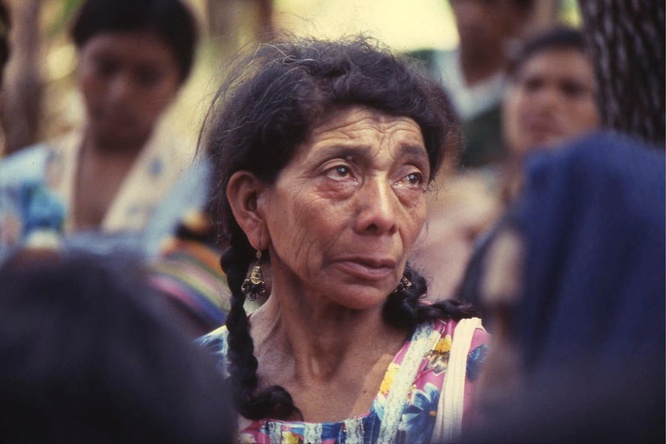 An older Guatemalan refugee women in a colourful dress 