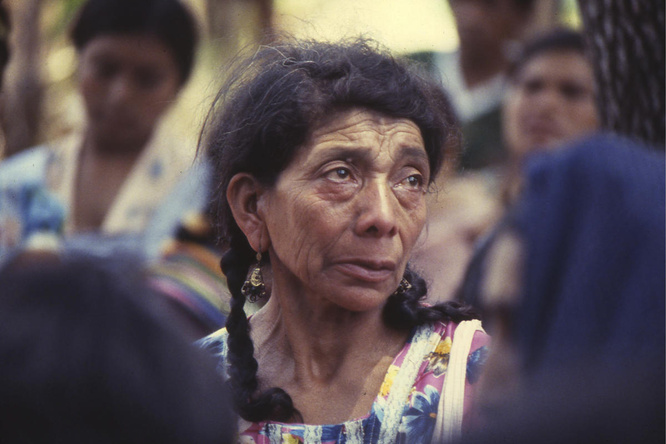 An older Guatemalan refugee women in a colourful dress 