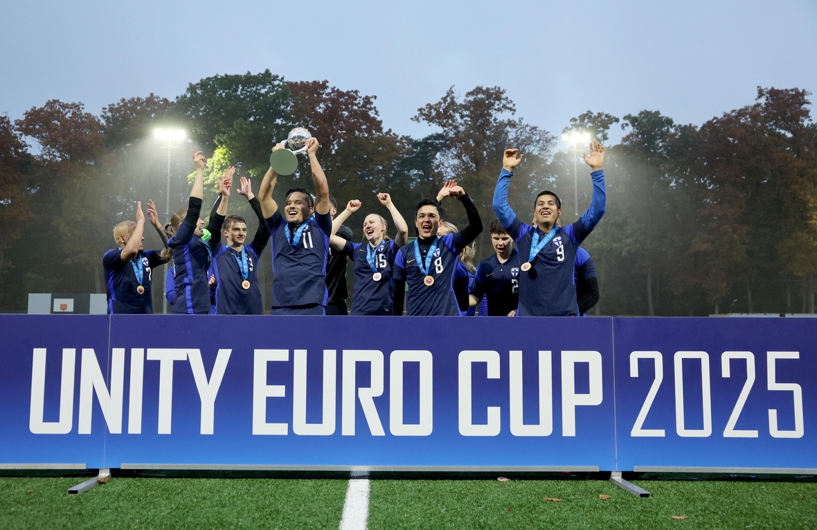 Team members from Finland cheer with joy and lift the Unity Euro Cup