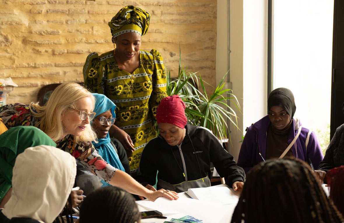Aminata Soucko, a gender-based violence survivor from Mali in West Africa and the founder of the Red Aminata  association, helps out with Spanish lessons for refugee women at the association’s office in Valencia, Spain, in October 2024.