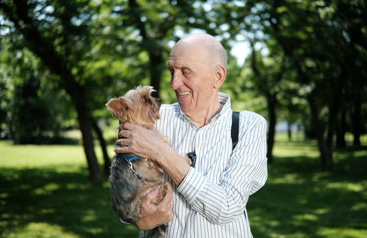 A man holding a small dog