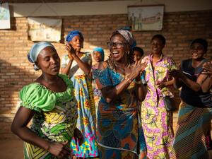 Women clap and dance together.