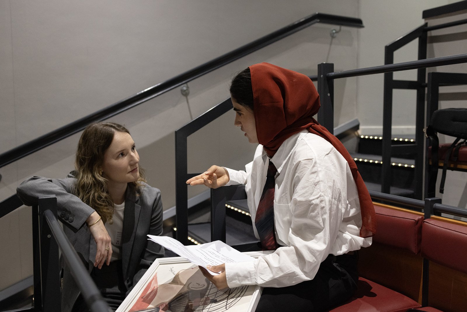 Shogofa, étudiante à l'Université Panthéon Assas et réfugiée d’Afghanistan, s'entretient avec un membre du HCR avant de monter sur scène.