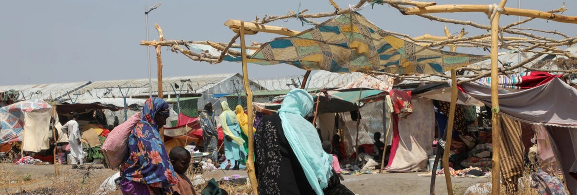 Newly arrived refugees from Sudan set up their shelter at the overcrowded Renk Transit Centre in South Sudan, March 2025