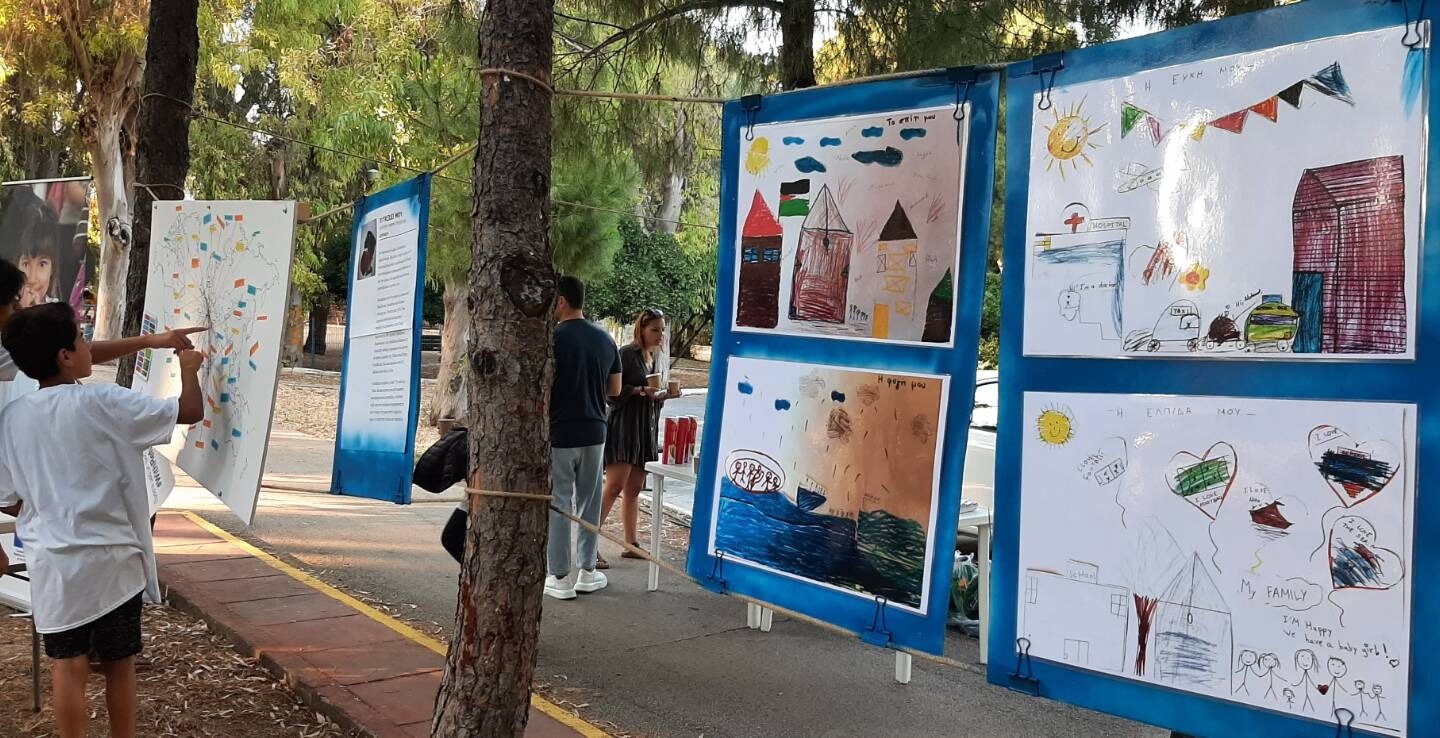 Drawings of refugee students under Chios Refugee Education Coordinators, entitled “My journey” in Chios Municipal Garden_II