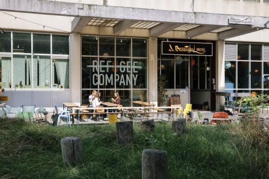 A building with Refugee company sign on window