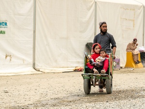 Hadigul is carrying her younger sisters, Sabria and Freshta