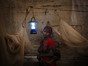 A solar-powered lantern helps this Somali mother and her child in their shelter eastern Ethiopia's Kobe Refugee Camp