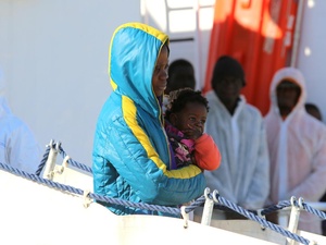 Italy. Migrants and refugees aboard the Italian Coast Guard vessel 'Corsi' arriving at the port of Augusta