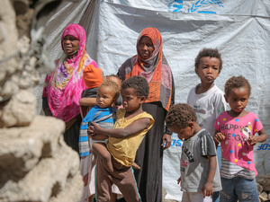 Displaced Yemeni mother, Gabra (in pink) and her family, in a hosting site in Sana'a.