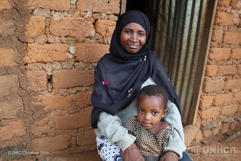 Burundian refugee Venancia Nibitanga, sits with her youngest daughter outside her home in Nduta refugee camp, Tanzania. © UNHCR/Christina John