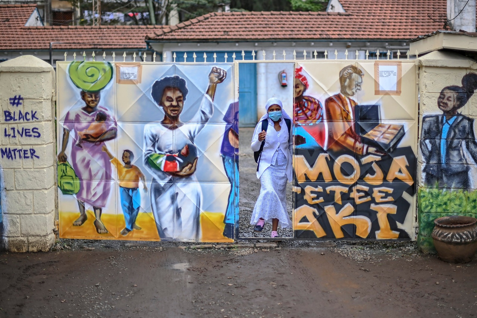 Nosizi Reuben leaves the Kenya Human Rights Commission office in Nairobi, where she is allowed free use of their wi-fi to study online. © UNHCR/Anthony Karumba