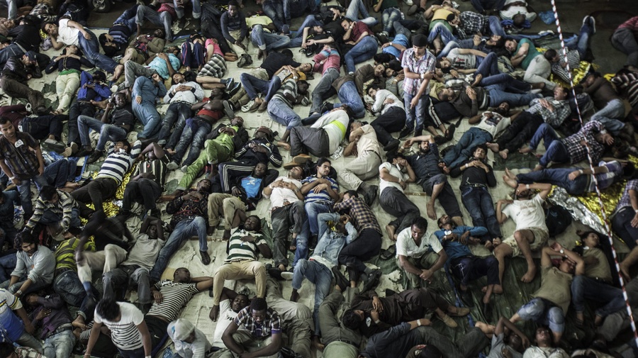 Asylum-seekers and economic migrants take to the seas, waiting out the dangerous journey in the boat's cramped cargo space.