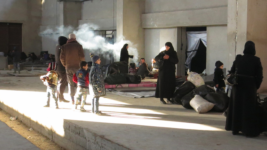 Newly displaced families from east Aleppo reach a shelter in Mahalej, Syria.