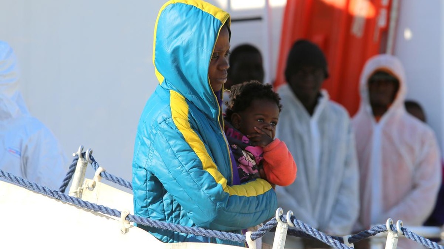 Italy. Migrants and refugees aboard the Italian Coast Guard vessel 'Corsi' arriving at the port of Augusta