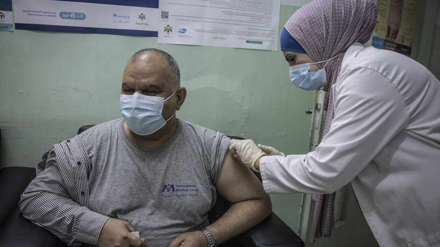 Iraqi refugee Ziad receives a dose of COVID-19 vaccine at the Irbid Vaccination Clinic in Jordan.