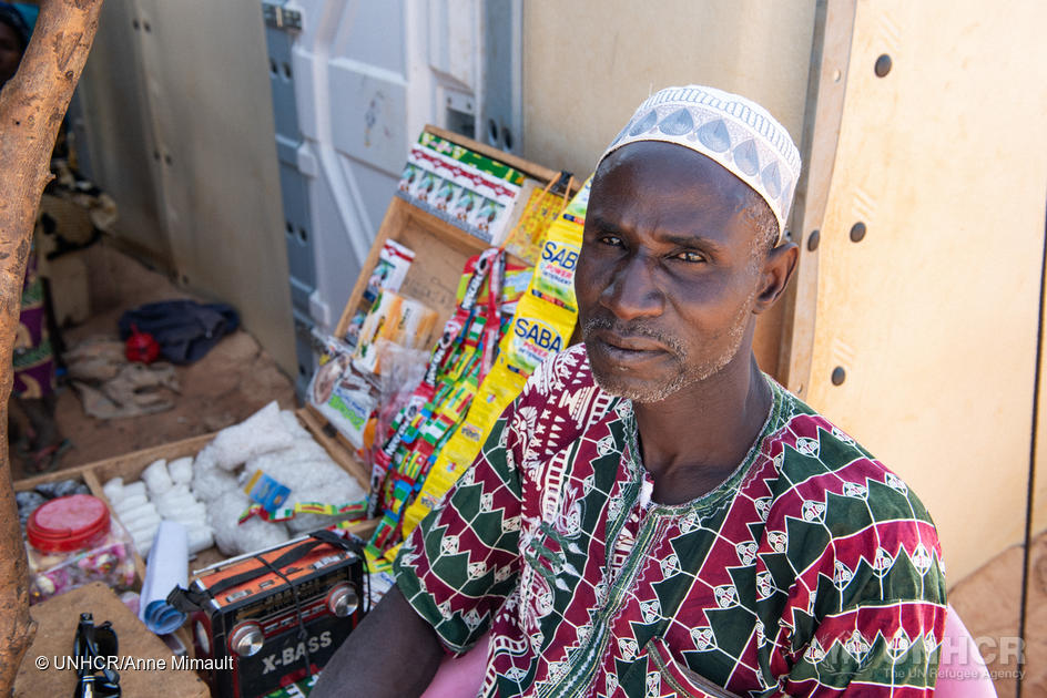 Sambo Maiga, 49, sells items in front of his shelter at a site for internally displaced persons in Kongoussi, Burkina Faso, West Africa.