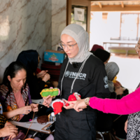 Guzelya visiting refugee women in Cisarua