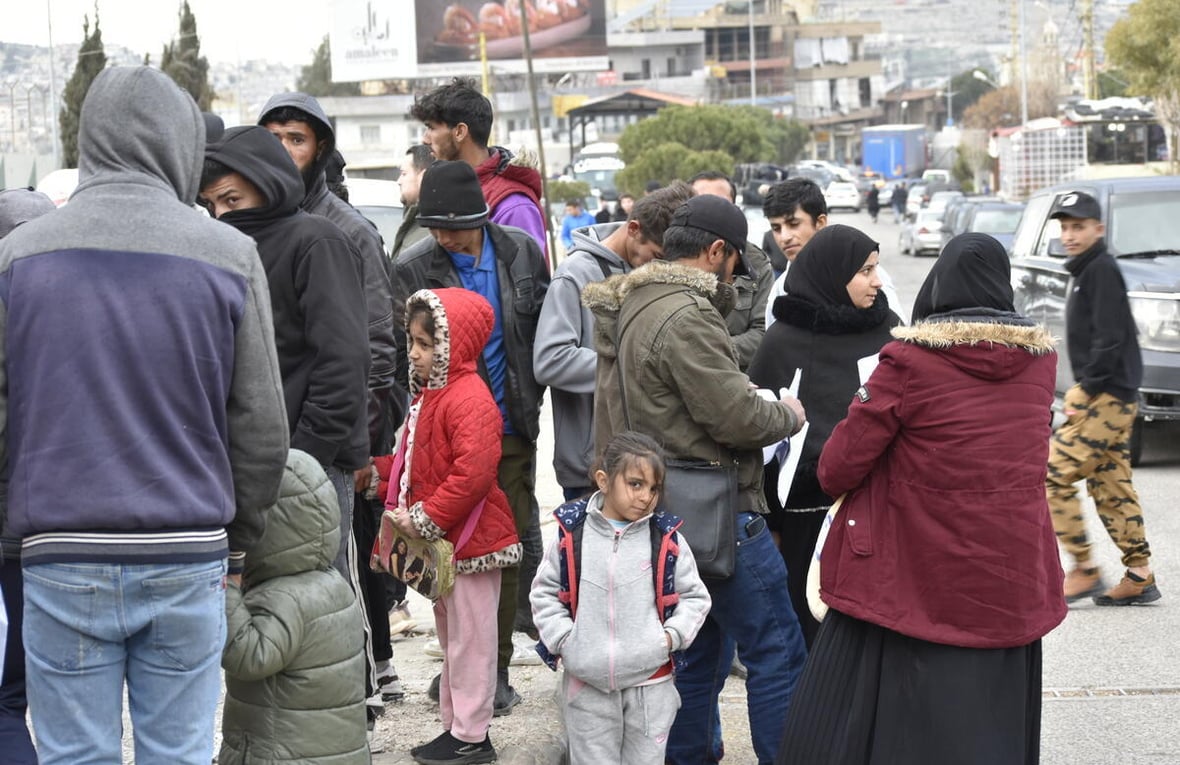 People gather outside at a border point.