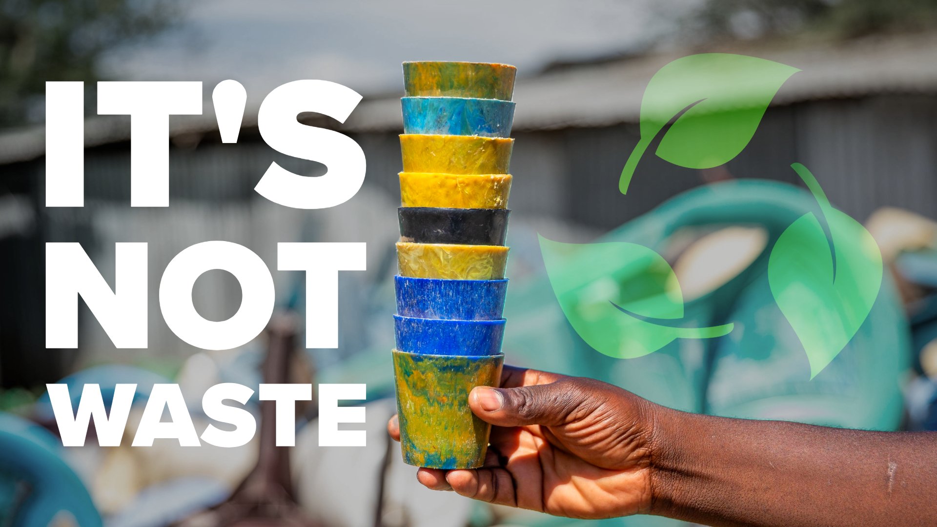 A man holding recycled plastic cups.