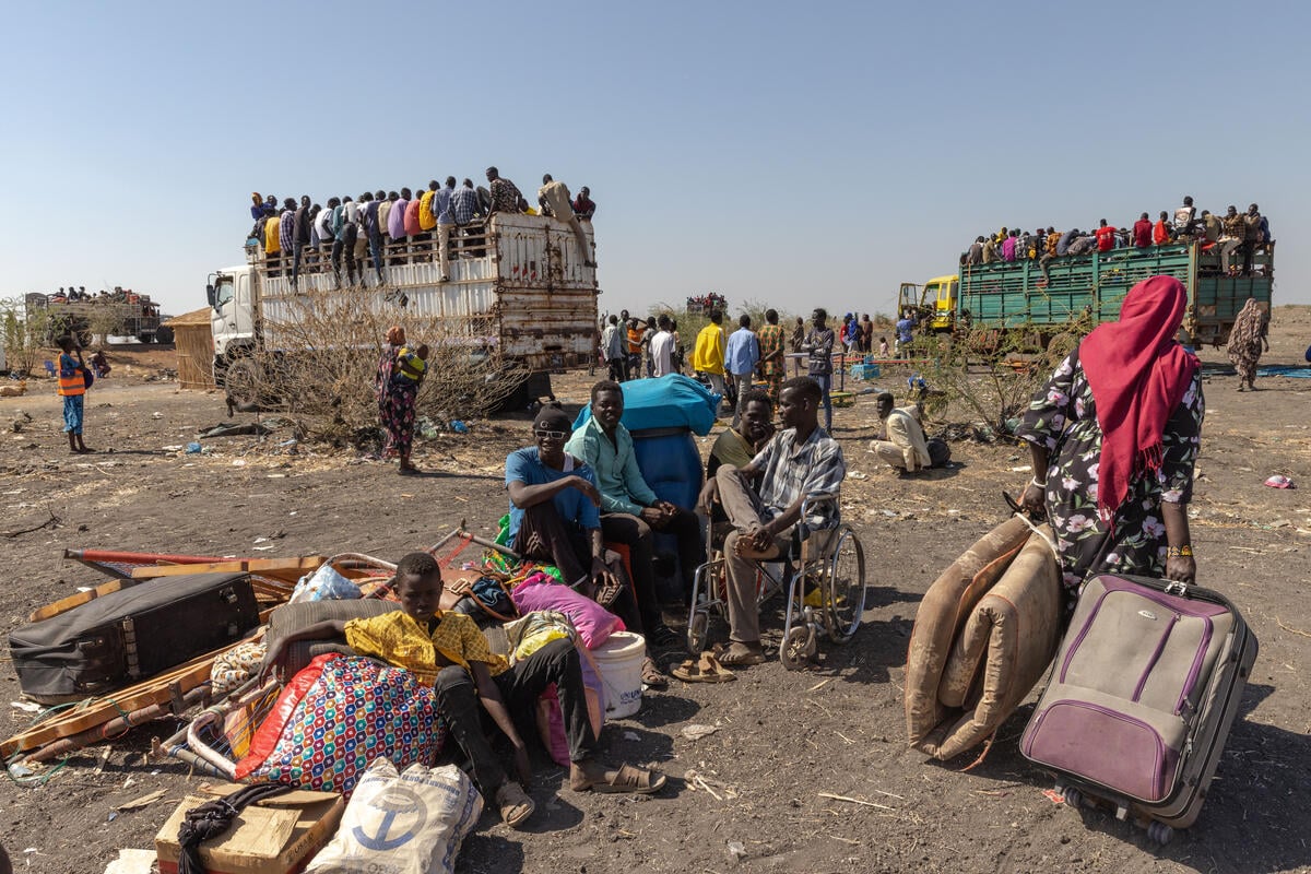 Refugees and returnees on board trucks at the Joda border point near Renk, South Sudan