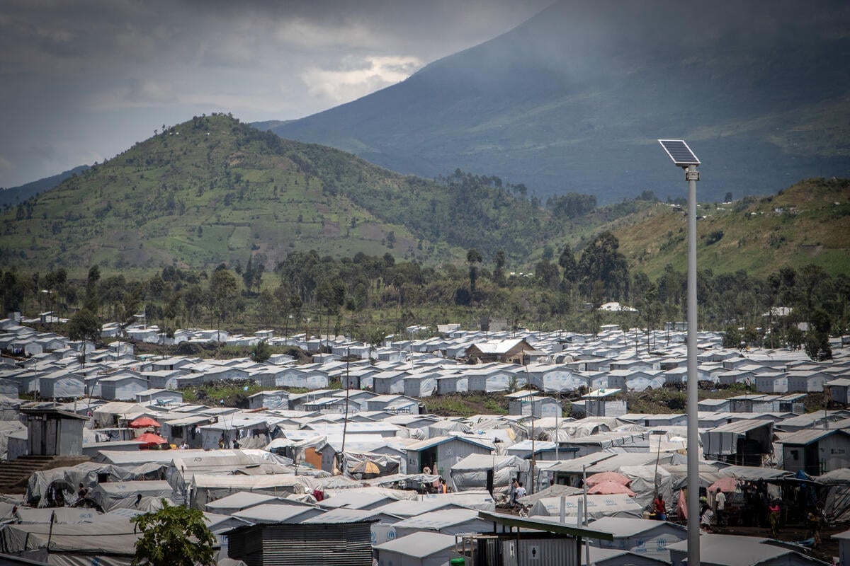 A displacement site surrounded by mountains on a cloudy day.