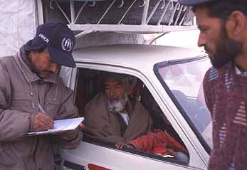 UNHCR staff verify internally displaced persons at a military checkpoint in Kabul.