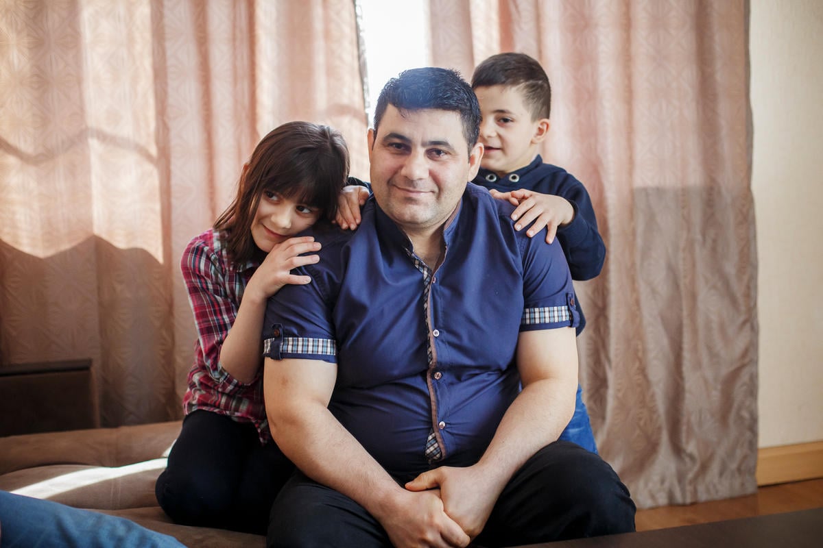 Belarus. A Syrian refugee and his children spend Sunday together in their new home in Gomel