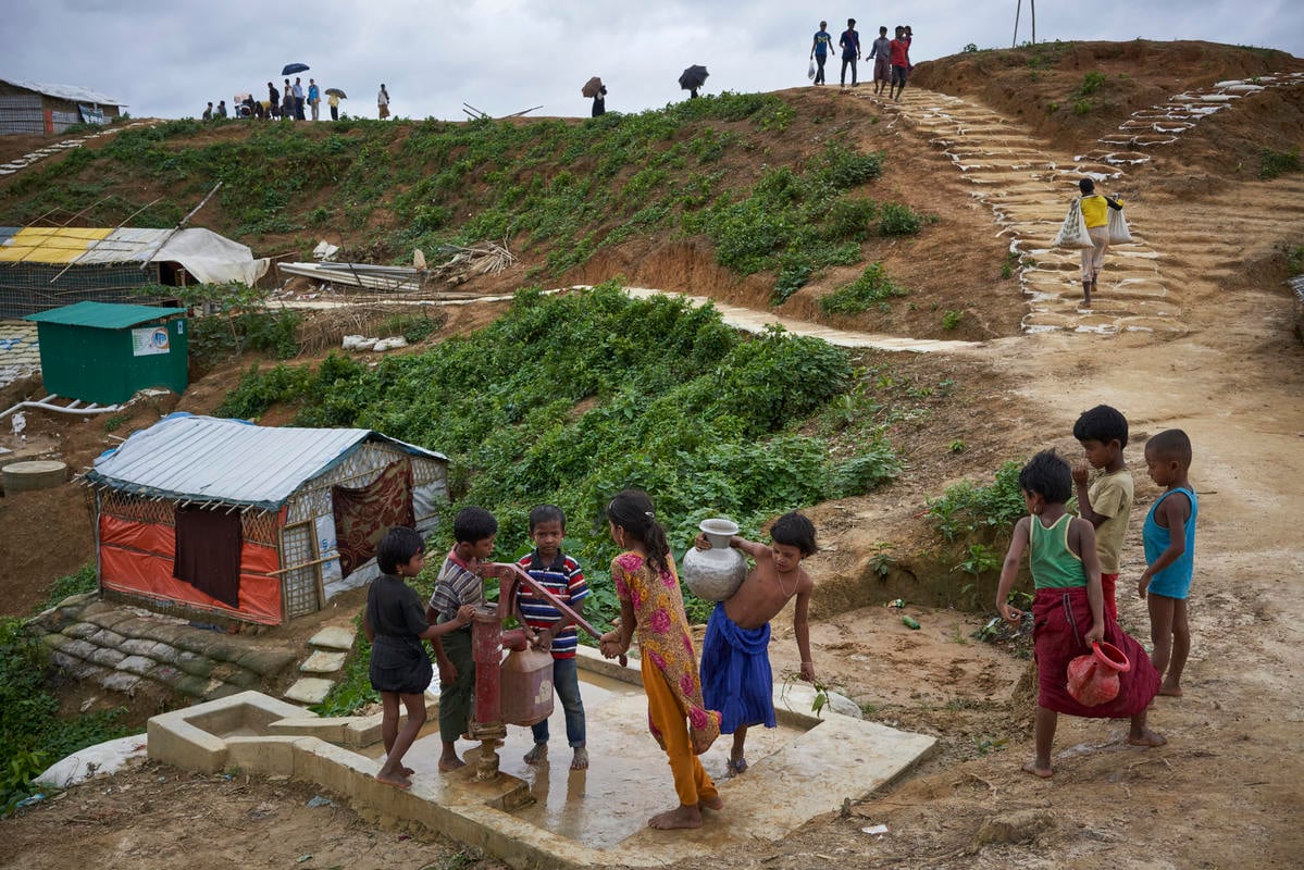 Bangladesh. Rohingya refugees fill containers at a water well in Kutupalong settlement