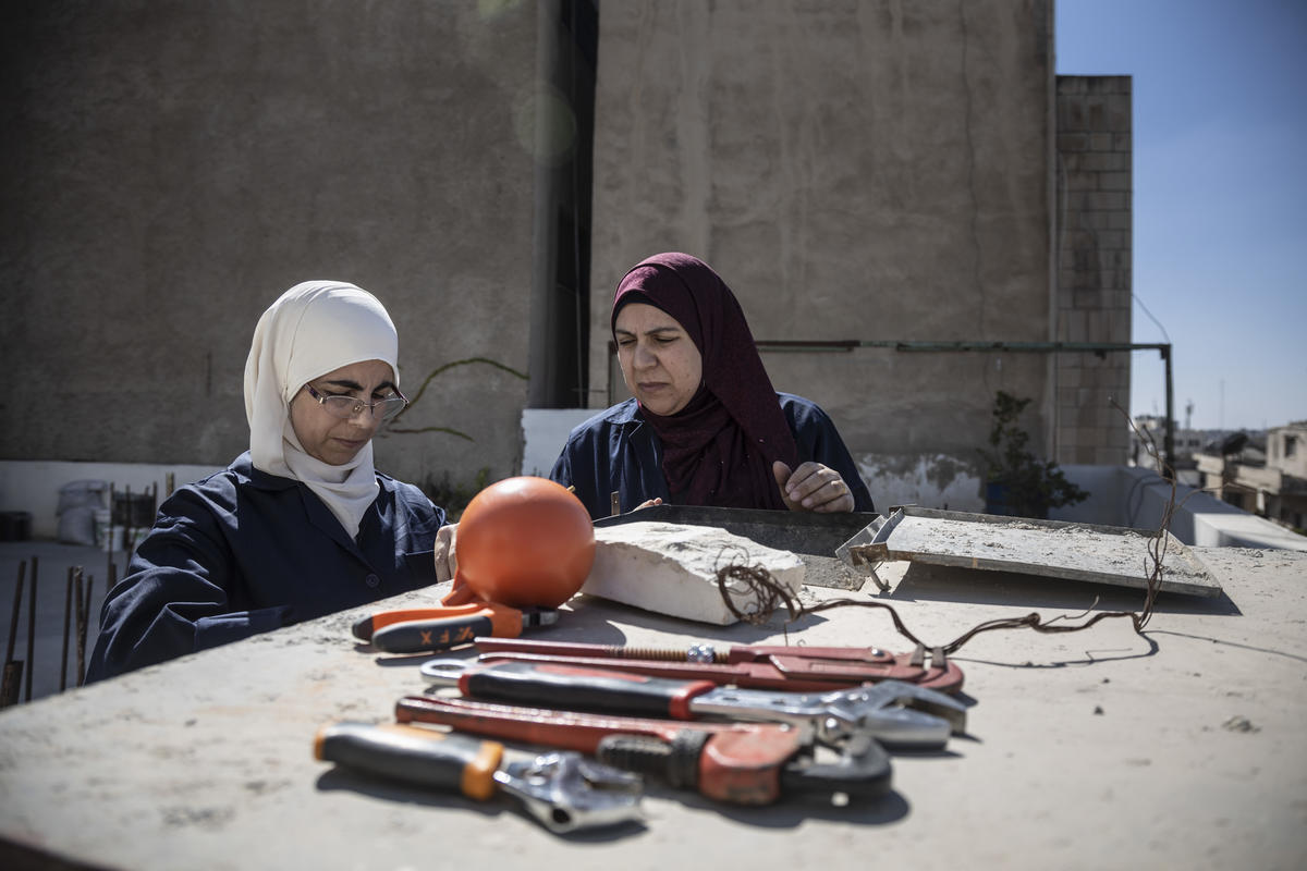 Jordan. Female plumber teaches refugees her trade