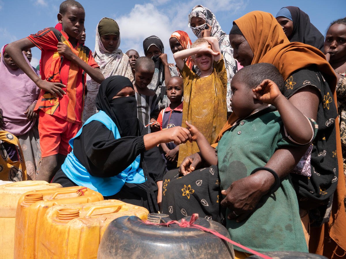 Somalia. Internally displaced Somalis queueing to fill their jerry cans with water