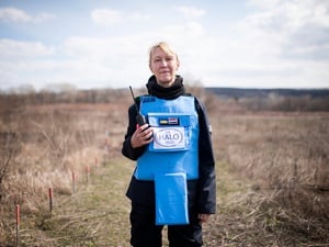 Ukraine. A female deminer in partially cleared minefield in the Donbas area