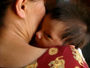 Turkmenistan. A woman holds her infant