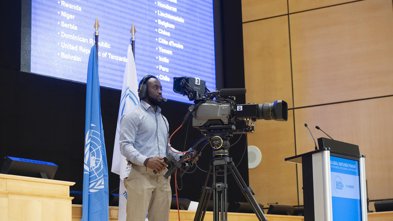 A cameraman films from the stage at the Palais des Nations. 