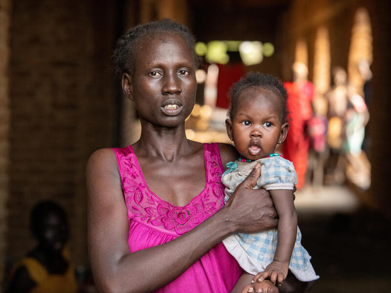 Mary, an internally displaced person, poses for a photo with her daughter at an IDP site in Malakal, South Sudan. 