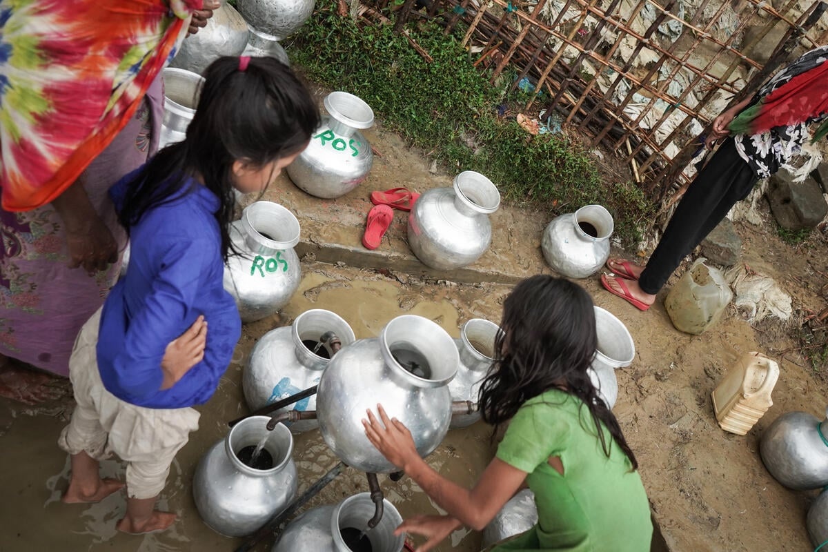 Women collect water at water points.