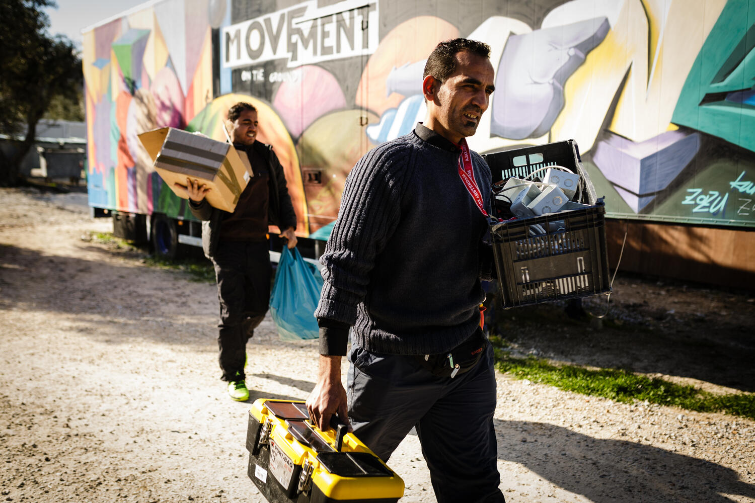 Greece. The Syrian electrician installing power at Lesbos refugee camp