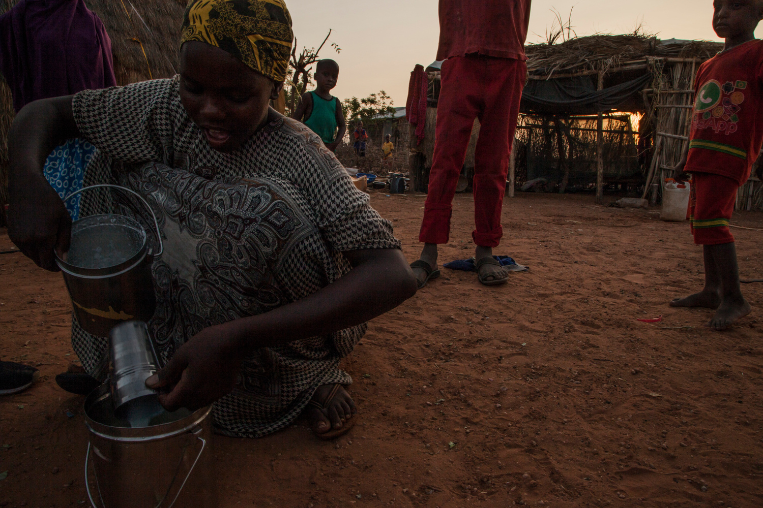 Ethiopia. Local farmer measures milk before selling it