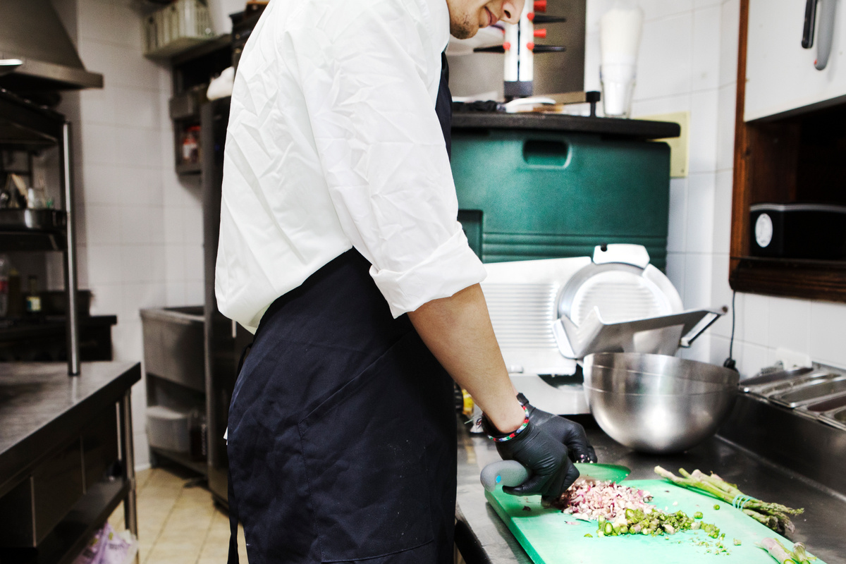 Spain. Unaccompanied Syrian refugee minor works in a local restaurant