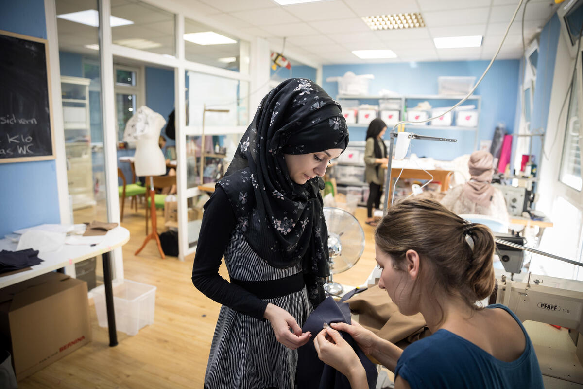 Germany. Refugee women got a job as a seamstress in a Frankfurt fashion workshop.
