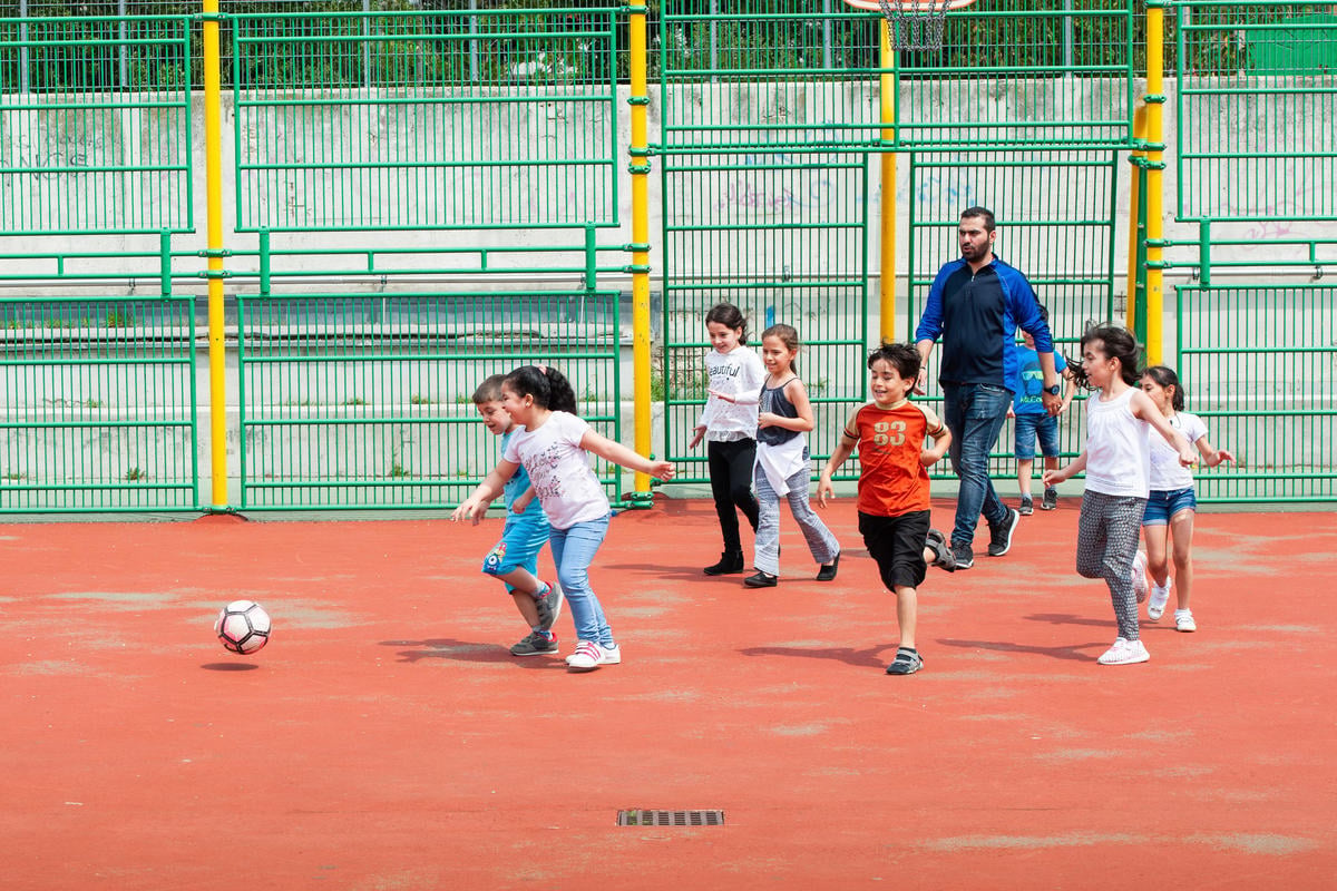 Children play football, one of the programs offered by "The Peace Bridge."